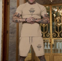 a man wearing a beige t - shirt and shorts