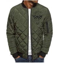 a man wearing a green bomber jacket with a black embroidered design